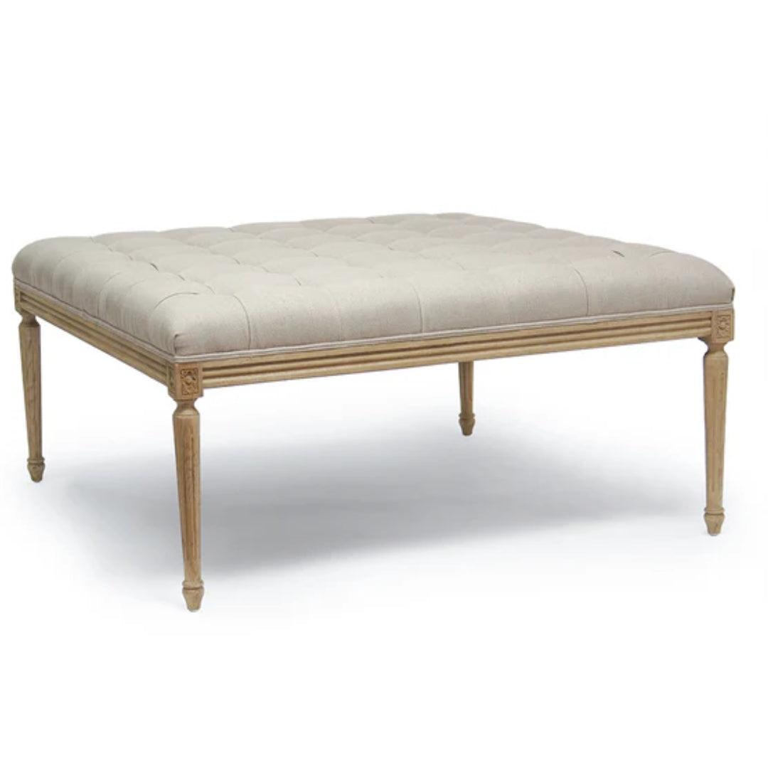 Pouf capitonné et rembourré avec pieds en bois sculpté